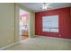 Dining room with red accent wall located next to updated kitchen at 7143 E Canyon Wren Dr, Gold Canyon, AZ 85118