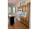 Kitchen featuring wood floors, an island, modern appliances, and wood cabinets at 7143 E Canyon Wren Dr, Gold Canyon, AZ 85118