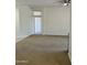 Bright living room with neutral carpet and paint and a doorway that leads to the bedrooms at 7143 E Canyon Wren Dr, Gold Canyon, AZ 85118