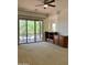 Bright living room featuring a ceiling fan, built-in cabinet, and a sliding glass door to the outdoor patio at 7143 E Canyon Wren Dr, Gold Canyon, AZ 85118
