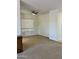 Neutral colored, carpeted living room showing the ceiling fan, window, and a built-in cabinet at 7143 E Canyon Wren Dr, Gold Canyon, AZ 85118