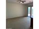 Spacious living room with a ceiling fan and sliding door to the outdoor patio at 7143 E Canyon Wren Dr, Gold Canyon, AZ 85118
