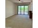 Spacious living room showcases neutral carpet, light walls, ceiling fan, and sliding glass door leading to an outdoor patio at 7143 E Canyon Wren Dr, Gold Canyon, AZ 85118
