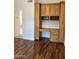 Bright home office with custom cabinetry and desk space and laminate flooring at 7143 E Canyon Wren Dr, Gold Canyon, AZ 85118