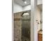 Custom tiled shower featuring a glass door and built-in shower head and fixtures at 7143 E Canyon Wren Dr, Gold Canyon, AZ 85118
