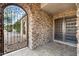 Elegant entryway with a wrought-iron gate and double wood doors at 7341 E Sutton Dr, Scottsdale, AZ 85260