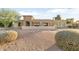 House exterior showcasing stone facade, landscaped yard, and a two-car garage at 7341 E Sutton Dr, Scottsdale, AZ 85260