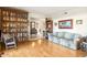 Living room featuring hardwood floors, a wood rocking chair, and built-in bookcase at 7341 E Sutton Dr, Scottsdale, AZ 85260