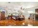 Main bedroom with hardwood floors, a king-size bed, and ample closet space at 7341 E Sutton Dr, Scottsdale, AZ 85260