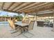 Covered patio with dining table and comfortable seating area at 7341 E Sutton Dr, Scottsdale, AZ 85260