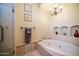 Bathroom with soaking tub, shower, and decorative niches at 8540 E Mcdowell Rd # 121, Mesa, AZ 85207