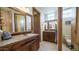 Large bathroom with double sinks and ornate wood cabinets at 8540 E Mcdowell Rd # 121, Mesa, AZ 85207