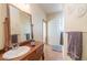 Bathroom features antique vanity, large mirror, and updated fixtures at 8540 E Mcdowell Rd # 121, Mesa, AZ 85207