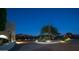 Landscaped front yard with a brick pathway at night at 8540 E Mcdowell Rd # 121, Mesa, AZ 85207