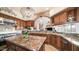 Large kitchen island, granite countertops, and ample wood cabinetry at 8540 E Mcdowell Rd # 121, Mesa, AZ 85207