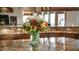 Kitchen island with granite countertop and flower arrangement at 8540 E Mcdowell Rd # 121, Mesa, AZ 85207