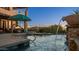 Inviting pool and spa with water features and patio umbrella at 8540 E Mcdowell Rd # 121, Mesa, AZ 85207