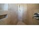 Walk-in shower with tiled walls and built-in shelving at 8540 E Mcdowell Rd # 121, Mesa, AZ 85207