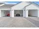 Three-car garage with three luxury cars parked inside at 1583 S 155Th St, Gilbert, AZ 85296