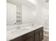 A bathroom with double sinks and a large mirror creates a bright and spacious feel at 17703 W Southgate Ave, Goodyear, AZ 85338