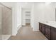 Bathroom featuring tile floors and a walk-in closet at 17703 W Southgate Ave, Goodyear, AZ 85338