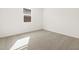 Bedroom featuring neutral carpet, window, and blank walls at 17703 W Southgate Ave, Goodyear, AZ 85338