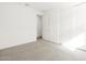 Bright bedroom with neutral carpet, walk-in closet and white doors at 17703 W Southgate Ave, Goodyear, AZ 85338