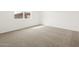 Bright bedroom showcasing neutral carpet and a large window at 17703 W Southgate Ave, Goodyear, AZ 85338