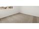 An empty carpeted bedroom in a new home features a double-paned window at 17703 W Southgate Ave, Goodyear, AZ 85338