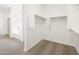 View from carpeted closet to a bathroom with a tub and shower in a new home at 17703 W Southgate Ave, Goodyear, AZ 85338
