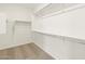 An empty closet with installed racks is carpeted and ready for plenty of storage at 17703 W Southgate Ave, Goodyear, AZ 85338