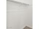 An empty closet with one rack is carpeted in this modern home at 17703 W Southgate Ave, Goodyear, AZ 85338