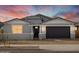 Charming single-story home with a well-manicured lawn, gray paint, and an attached two-car garage at 17703 W Southgate Ave, Goodyear, AZ 85338
