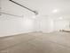 Spacious garage featuring a concrete floor and white walls at 17703 W Southgate Ave, Goodyear, AZ 85338