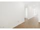 A hallway with clean white walls and stylish wood-look tile flooring at 17703 W Southgate Ave, Goodyear, AZ 85338