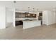 Open kitchen featuring dark cabinets, granite countertops, and stainless steel appliances at 17703 W Southgate Ave, Goodyear, AZ 85338