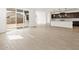 Open living room with access to the patio and views of the kitchen at 17703 W Southgate Ave, Goodyear, AZ 85338