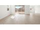 Bright living room features wood-look tile flooring and sliding glass door to the back yard at 17703 W Southgate Ave, Goodyear, AZ 85338