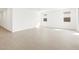 Large open living space features wood-look tile flooring and bright, white walls at 17703 W Southgate Ave, Goodyear, AZ 85338