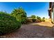 Backyard with trees and gravel, and a stone path leading to a pergola at 20856 E Arroyo Verde Dr, Queen Creek, AZ 85142