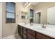 Bathroom boasts a double sink vanity, large mirror and natural lighting at 20856 E Arroyo Verde Dr, Queen Creek, AZ 85142