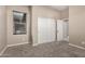Bedroom features a closet with sliding doors, a window with blinds, and neutral walls at 20856 E Arroyo Verde Dr, Queen Creek, AZ 85142