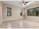 Bright, neutral bedroom with tile flooring, a ceiling fan, and multiple windows for great natural light at 20856 E Arroyo Verde Dr, Queen Creek, AZ 85142