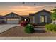 Charming single-story home with desert landscaping, two-car garage, and beautiful twilight sky at 20856 E Arroyo Verde Dr, Queen Creek, AZ 85142