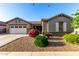 Charming single-story home featuring a well-manicured lawn, lovely desert landscaping, and a two-car garage at 20856 E Arroyo Verde Dr, Queen Creek, AZ 85142