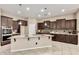 Gourmet kitchen showcasing island with granite countertops, dark cabinets and modern stainless steel appliances at 20856 E Arroyo Verde Dr, Queen Creek, AZ 85142
