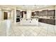Spacious kitchen featuring a large island, stainless steel appliances, granite countertops and tiled floor at 20856 E Arroyo Verde Dr, Queen Creek, AZ 85142