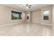 Open living area with tiled flooring, a ceiling fan and large window with blinds at 20856 E Arroyo Verde Dr, Queen Creek, AZ 85142