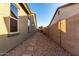 Narrow side yard with gravel and a stone path separating two buildings at 20856 E Arroyo Verde Dr, Queen Creek, AZ 85142