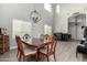 Bright dining room boasts high ceilings, stylish chandelier, and a modern fireplace at 28677 N Roselite Ln, San Tan Valley, AZ 85143